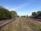 Looking down rail line with adjacent gas pipe and expansion loop