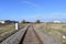 Looking down rail track with industrial background