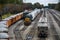 Looking down on a railroad yard. A row of loaded gravel cars are on one line.