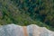 Looking down from rock cliff in onto trees and tree tops