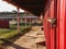 Looking down the side of a red barn