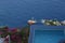 Looking down to the wooden sailboat anchored in Santorini.