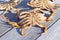 Looking down at the underside of three male Dungeness crabs on a dock