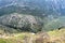 Looking down into the valley of olive groves from Delphi Greece with mountians in the background