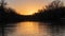 Looking downriver from the middle of the river while on a boat during the sunset