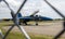 Looking through a fence at US Navy Blue Angels Jet with its cockpit open