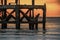 Looking out at Broken old structure remains of pier  in the during beautiful twilight in the sea