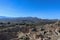 Looking out over the hill fort at Mycenae Greece and the museum and parking lot and over farmland and olive groves to the