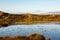 Looking out over a loch on the Hebridean island of North Uist, with evening light