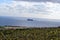 Looking out to sea at the island of Fifla, out across countryside and fields