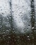 Looking out of a window covered with rain drops.