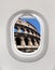 Looking out the window of a plane to the Colosseum in Rome