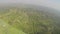 Looking out the window of a prop plane flying over Ugandan countryside