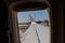 Looking Outside a Window of an Aircraft Cabin: White Airplane Wing