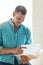 Looking over his creative brief. a handsome young businessman looking over some paperwork in a modern office.