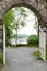 Looking through a stone arch onto Lake Windermere with moored boats