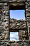 Looking Thru Ancient Windows at A Blue Sky with Bare Branches and Clouds