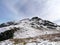 Looking to walkers on a snow-capped Arnison Crag, Lake District