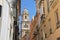 Looking towards the Cathedral through the city narrow streets, in the downtown, Malaga,  Andalusia, Southern Spain