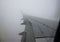 Looking trough window of an aircraft plane wing in fog.