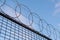 Looking up at circular barbed wire fence.