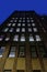 Looking up at a facade of a tall brick building on Manhattan`s Upper East Side at night, New York City