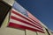 Looking up at a giant  American flag on the side of a hangar building