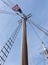 Looking up the mast rigging of a sailboat with American Flag on top