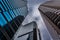 Looking up at modern buildings under a cloudy sky in Philadelphia, Pennsylvania.