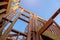 Looking up new construction beams under a clear blue sky with sunlight