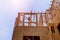 Looking up new construction beams under a clear blue sky with sunlight