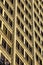 Looking up at older architectural brick and stone office building, symmetrical and modular