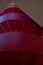 Looking up red spiral staircase on the Queen Mary campus, University of London, Mile End. Staircase is lit from above.