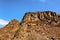 Looking up at ridge under blue skies