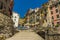 Looking up the slipway towards the tall, colourful houses surrounding the harbour in the Cinque Terre village of Riomaggiore