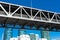 Looking up at the span section of San Francisco - Oakland Bay Bridge on a sunny day with blue sky.