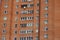 Looking up to red (orange) brick with many windows, Lasnamae, Tallinn, Estonia, Europe. 2024