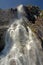 Looking up to a waterfall along rocks in Lysefjord, Norway