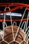 Looking up at the top of a basketball falling through the net with arena lights in the background