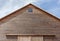 Looking up the top of gabled roof on a wooden barn