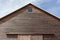 Looking up at the top of a gabled roof on a wooden barn