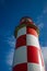 Looking up at Towering Red and White Lighthouse