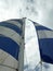 Looking up at two sails on a sailboat