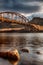 Looking up from the waterâ€™s edge to the bridge