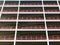 Looking upwards view of large modern commercial building under construction with steel beams and girders with orange safety fences