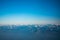 Looking through the window aircraft during flight a snow covered Italian and Osterreich Alps with blue sky without clouds