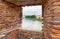 Looking through a window at Castelvecchio bridge or Scaligero bridge in Verona, Italy. It is one of the symbols of the city.