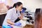 Always on the lookout for a cure. a young scientist taking notes while using a microscope in a laboratory.