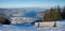 Lookout point with resting bench at wallberg mountain, view to lake tegernsee in winter