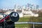 Lookout telescope monocular with blurred Canary Wharf district in London at distance